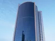 The iconic Bahrain Financial Harbour, a striking example of modern architecture with its twin towers soaring into a blue, cloud-dotted sky—home to prestigious Servcorp serviced offices,